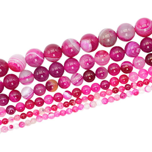 Strand of heat-treated pink Agate beads